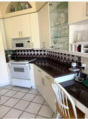 a kitchen with a stove a sink and a microwave