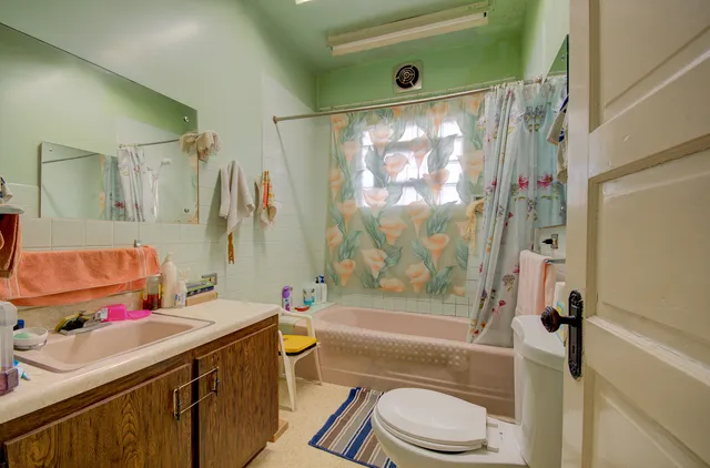 a bathroom with a sink toilet and shower