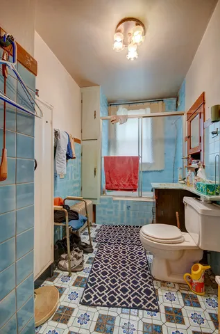 a bathroom with a toilet a sink and a mirror