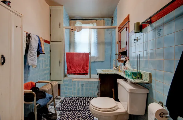 a bathroom with a toilet a sink and a shower curtain