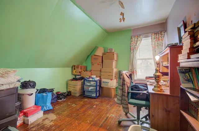 a bedroom with furniture and a window