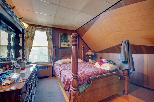 a bedroom with bed and a window