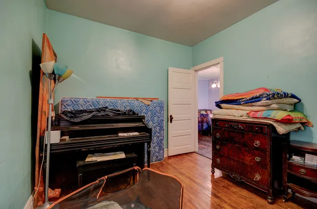 a bedroom with a bed and a dresser