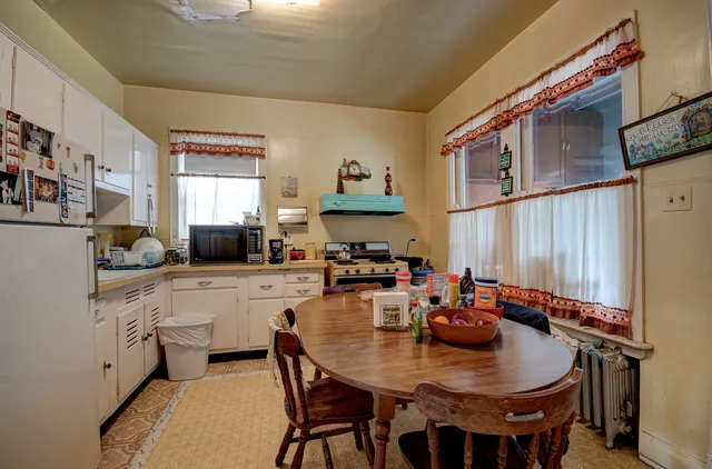 a kitchen with a table chairs and a stove