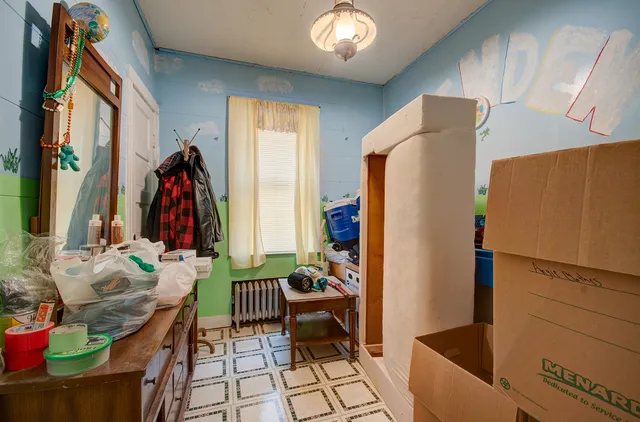 a bedroom with furniture and a window