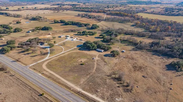 a view of a dry yard with trees