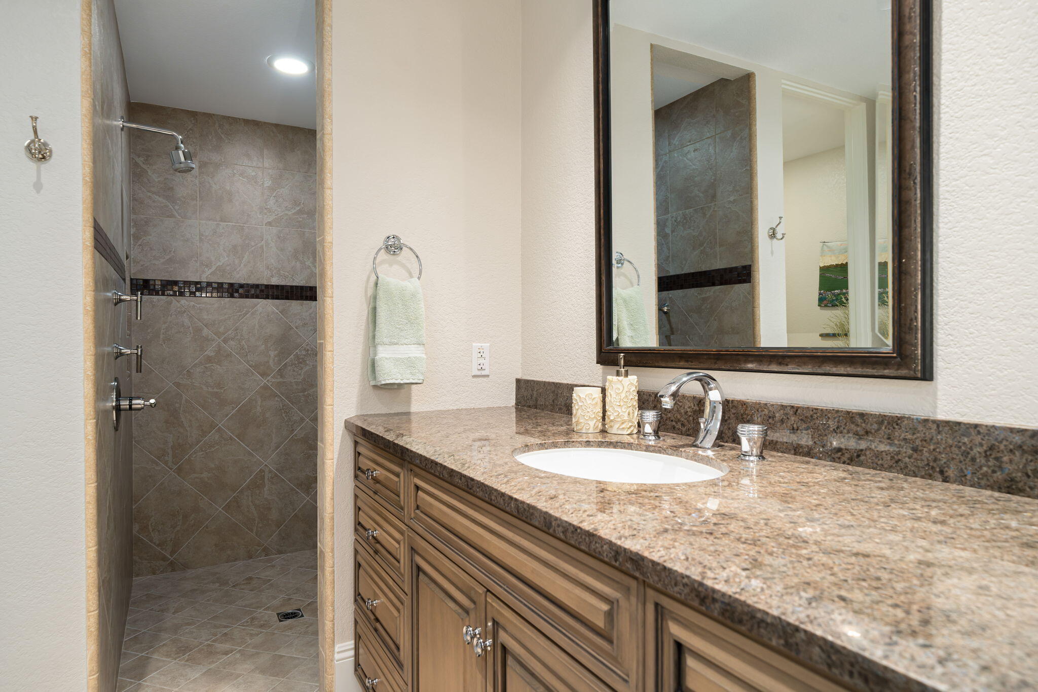 6 Oxford Court Rancho Mirage, CA 92270 - Photo 17 of 42 a bathroom with a granite countertop sink a mirror and shower