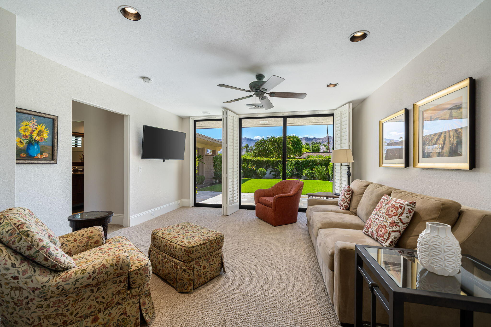 6 Oxford Court Rancho Mirage, CA 92270 - Photo 18 of 42 a living room with furniture large window and a flat screen tv