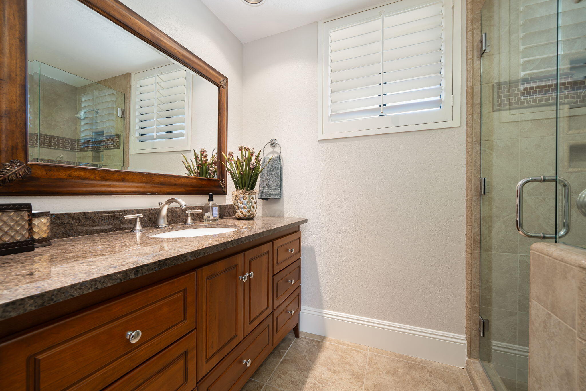 6 Oxford Court Rancho Mirage, CA 92270 - Photo 19 of 42 a bathroom with a granite countertop sink and a window