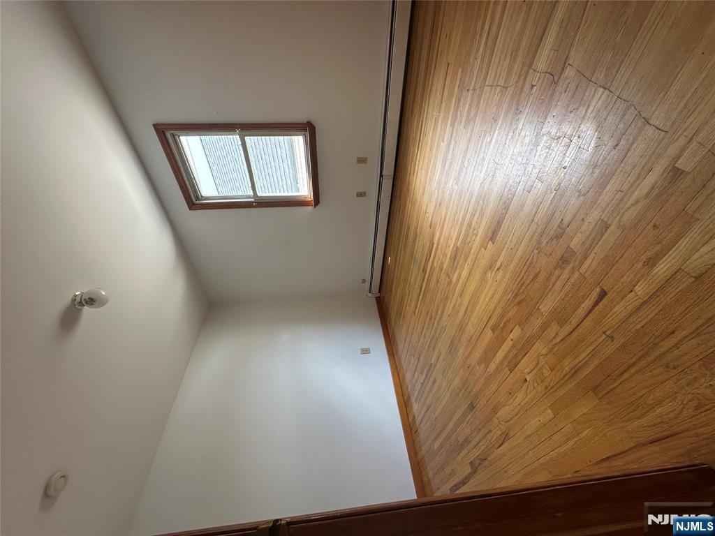 404 North 3rd Street, Unit 2 Harrison, NJ 07029 - Photo 5 of 9 an empty room with wooden floor and windows