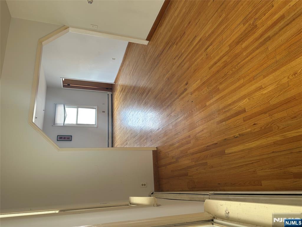 404 North 3rd Street, Unit 2 Harrison, NJ 07029 - Photo 8 of 9 an empty room with wooden floor and a window