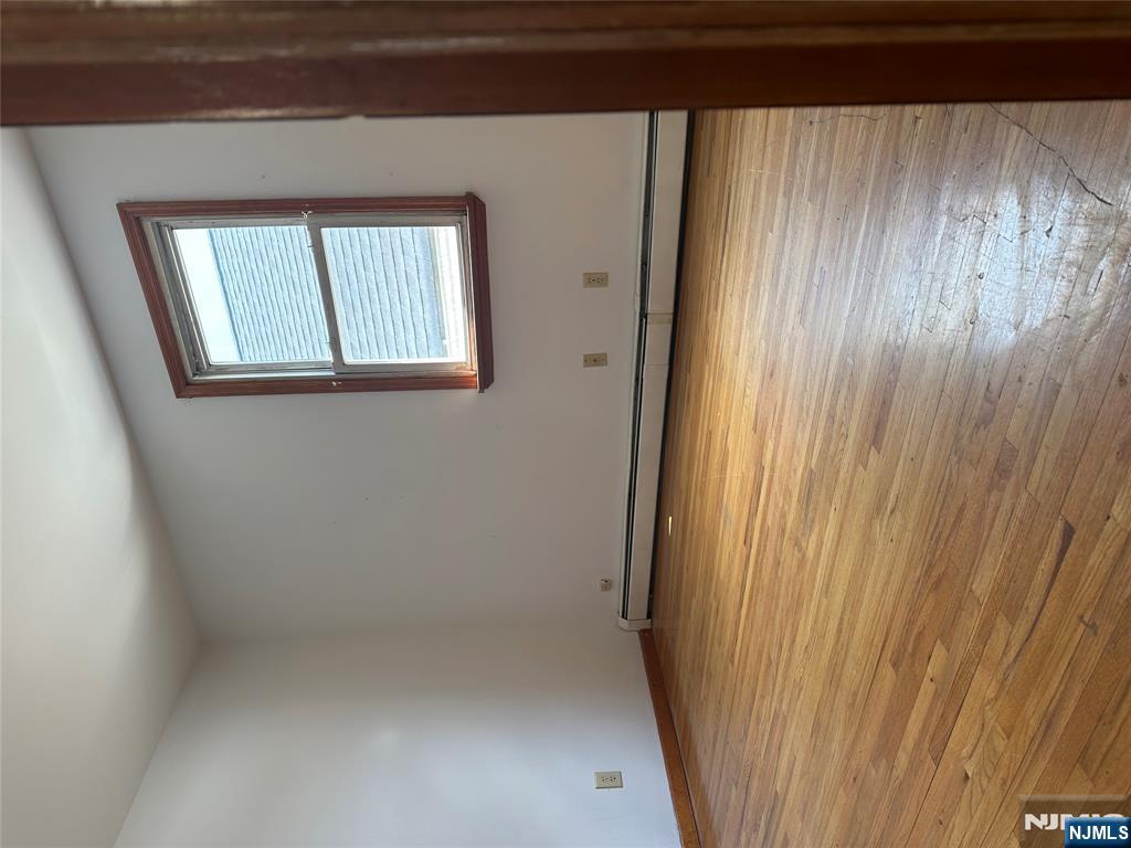 404 North 3rd Street, Unit 2 Harrison, NJ 07029 - Photo 9 of 9 an empty room with wooden floor and windows
