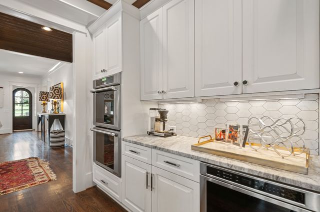 a kitchen with a stove and a refrigerator