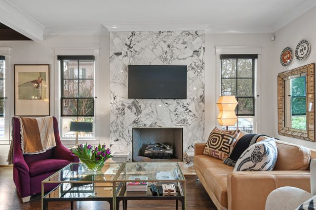 a living room with furniture fireplace and window