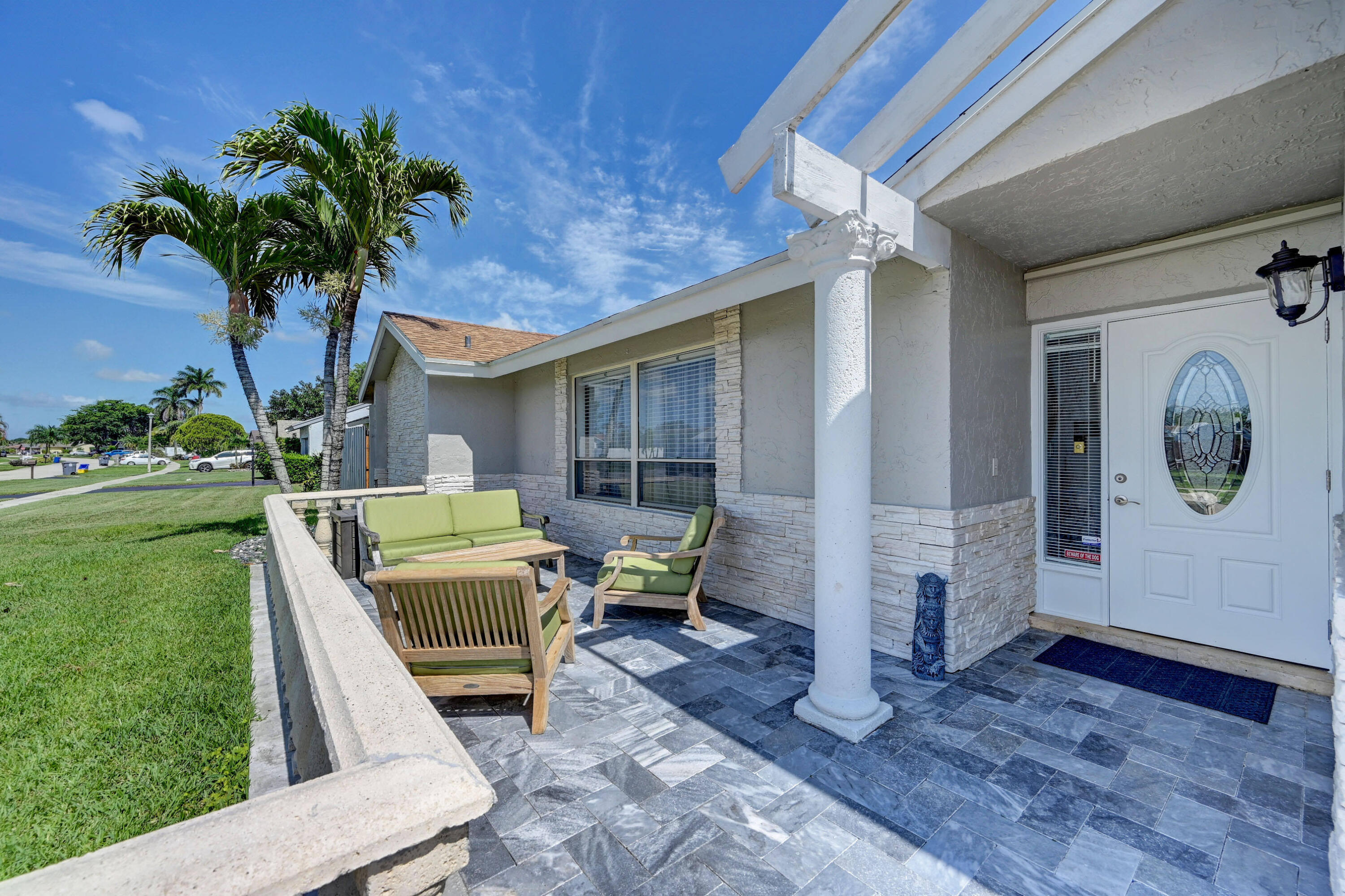 9682 Ohio Place Boca Raton, FL 33434 - Photo 3 of 37 a front view of a house with garden