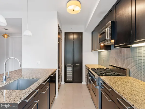a kitchen with granite countertop stainless steel appliances and wooden cabinets