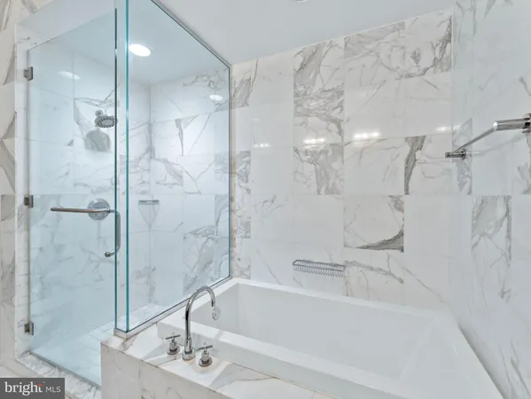a bathroom with a bathtub and shower