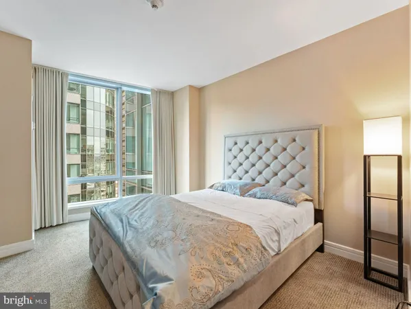a bedroom with a large bed and a large window
