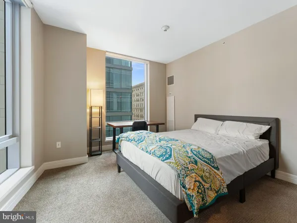a bed sitting in a bedroom next to a window
