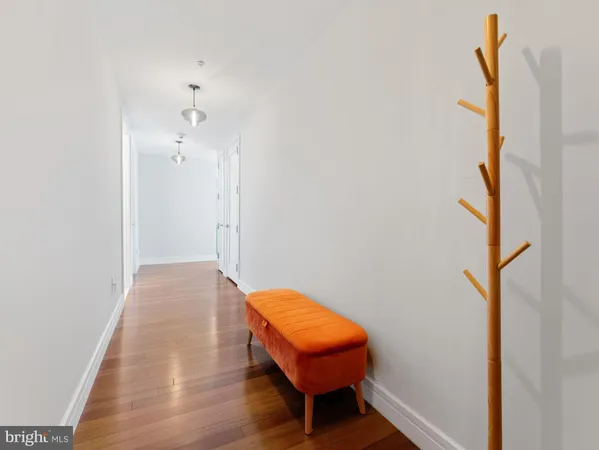 a view of a bedroom with a bed and a mirror