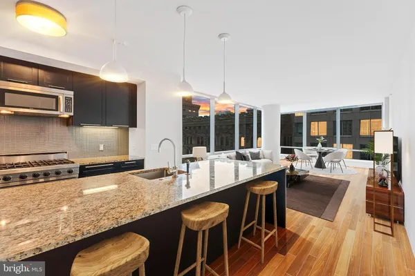 a large kitchen with a table and chairs