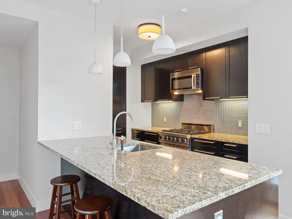 a kitchen with a sink a microwave and stove
