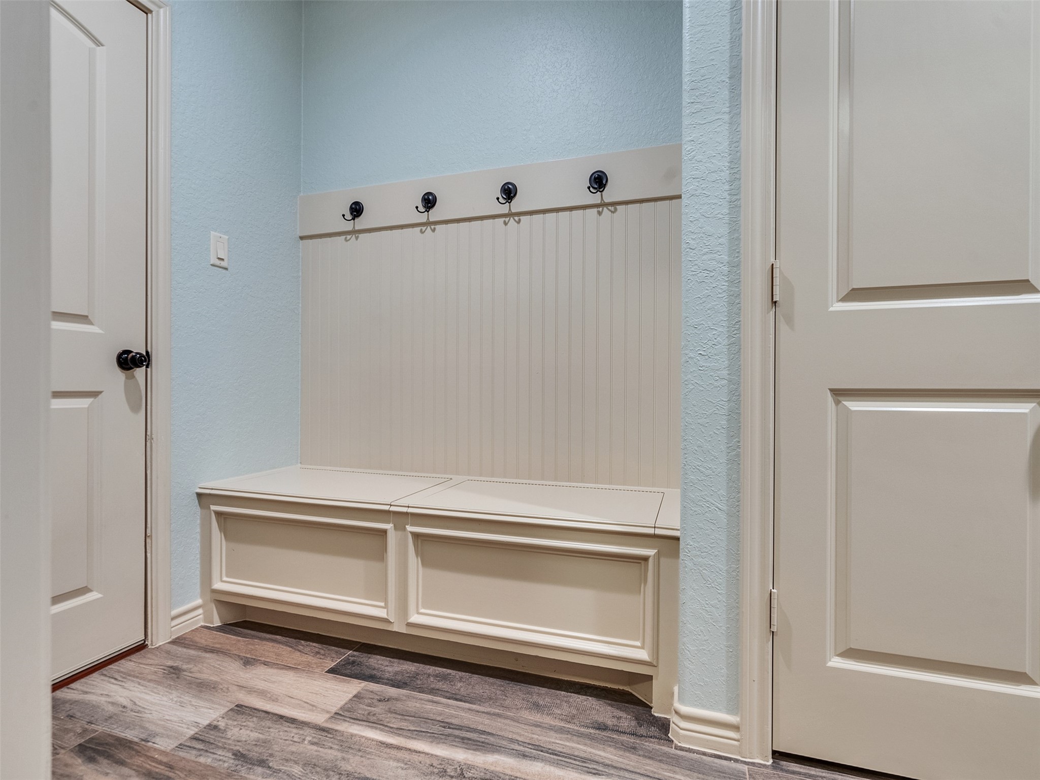 18005 Cindy Lane Conroe, TX 77302 - Photo 39 of 49 This photo showcases a tidy mudroom with a built-in bench featuring storage and coat hooks.