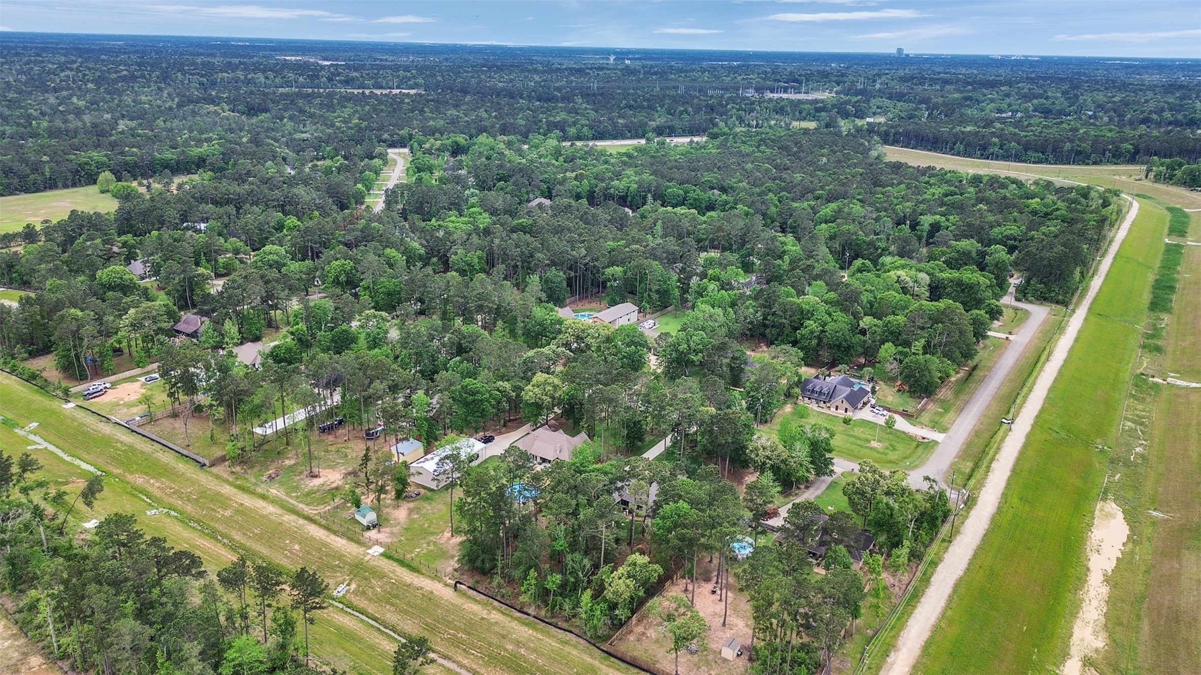 18005 Cindy Lane Conroe, TX 77302 - Photo 47 of 49 This aerial photo showcases a serene, wooded neighborhood with spacious lots, offering privacy and lush greenery. Ideal for those seeking a peaceful, nature-rich setting.