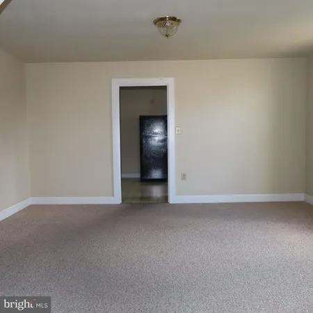 a view of an empty room with a closet