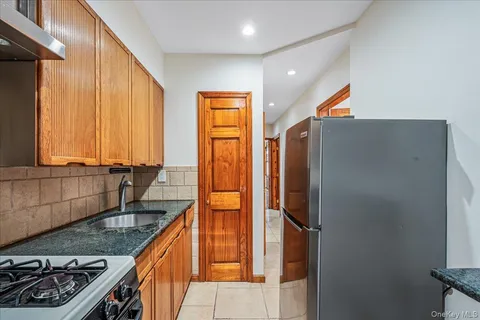 a kitchen with stainless steel appliances granite countertop a refrigerator and a sink