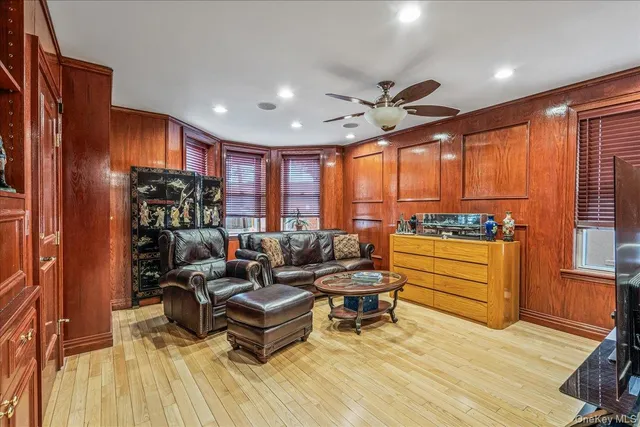 a living room with furniture a rug and a large window
