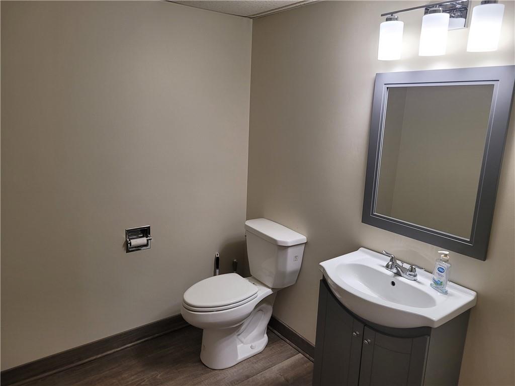 1235 South Center Street Extension, Unit B Grove City, PA 16127 - Photo 3 of 11 a bathroom with a toilet sink and mirror