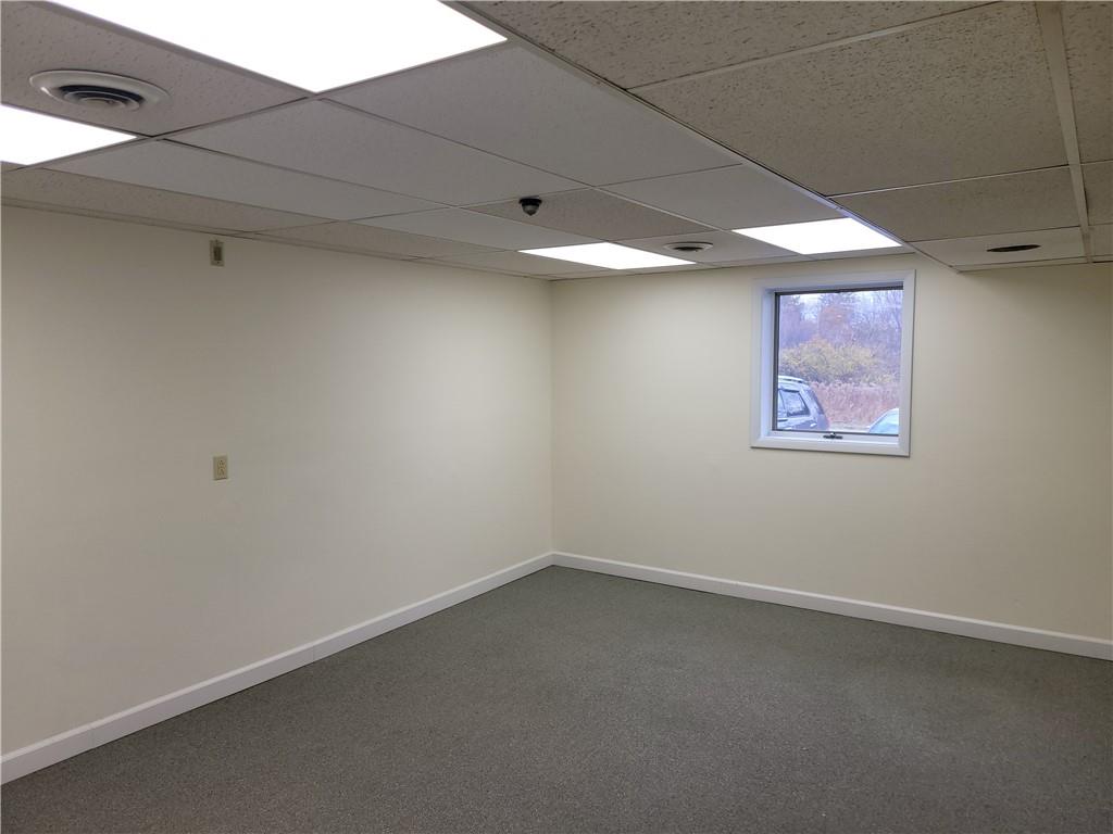 1235 South Center Street Extension, Unit B Grove City, PA 16127 - Photo 8 of 11 an empty room with a ceiling fan and window