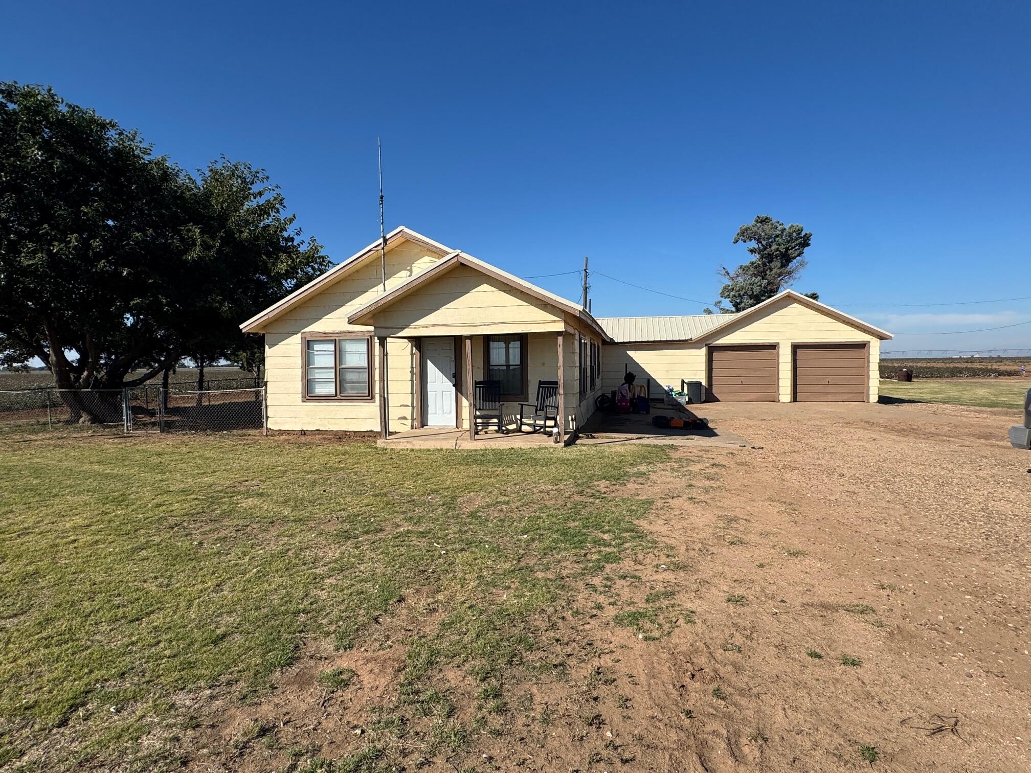 740 Sun Road Plainview, TX 79072 - Photo 11 of 15 a front view of a house with a garden and yard