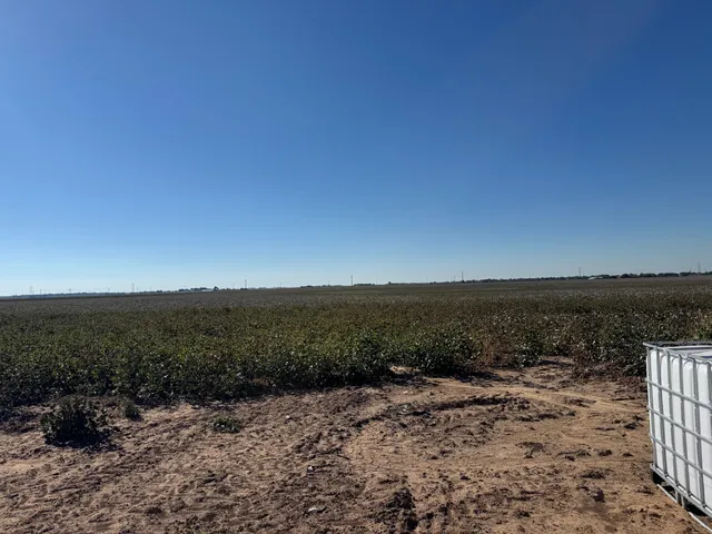an aerial view of house with yard and mountain view in back