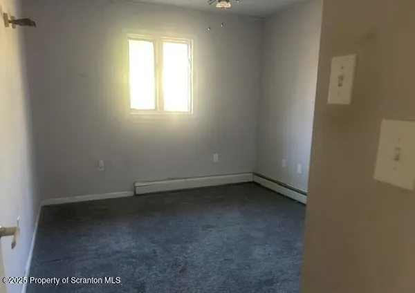 a bathroom with a light fixture a toilet and a sink