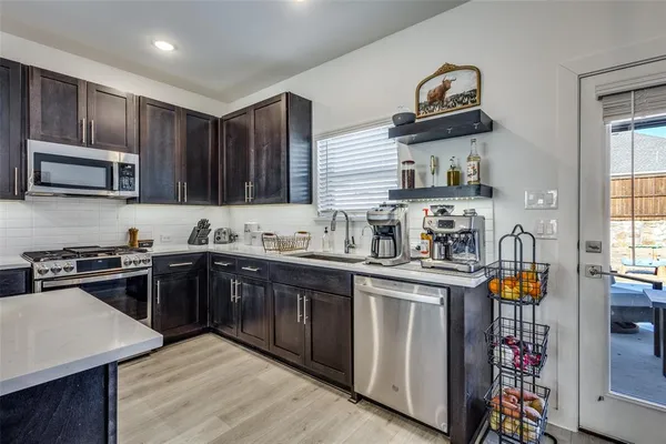 a kitchen with stainless steel appliances granite countertop a stove and a sink