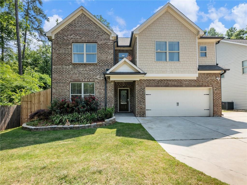 258 Oak Road Southwest Lawrenceville, GA 30044 - Photo 1 of 1 a front view of a house with a yard and garage