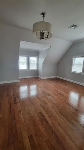 a view of a hallway view with wooden floor and staircase