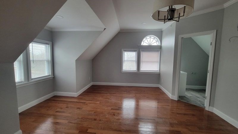 761 Highland Avenue, Unit 7 Fall River, MA 02720 - Photo 5 of 7 an empty room with wooden floor and windows