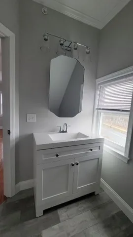 a bathroom with a sink and mirror