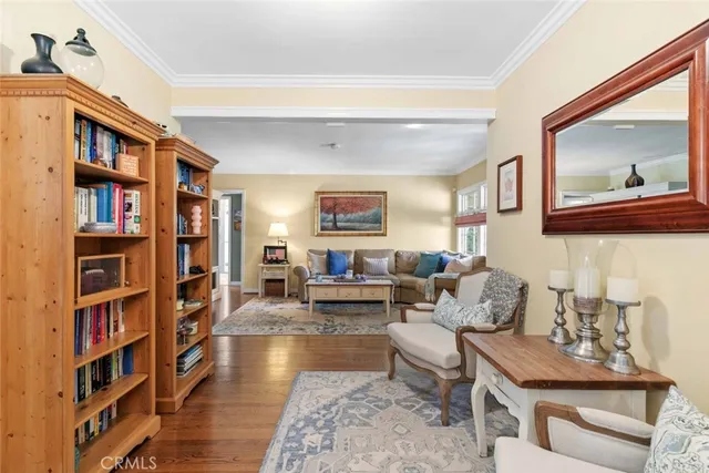 a dining room with furniture potted plants and wooden floor