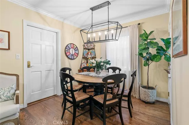 a dining room with furniture a rug and a chandelier
