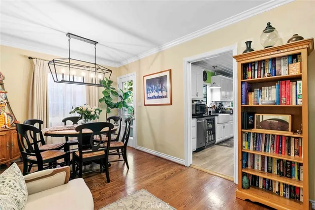 a kitchen with stainless steel appliances granite countertop a stove a sink dishwasher and cabinets with wooden floor