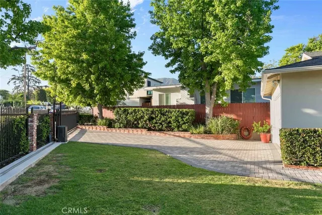 a view of a patio with couches table and chairs and potted plants