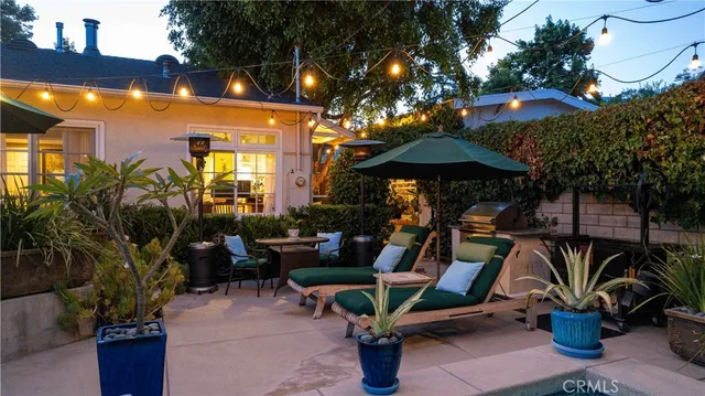 a front view of a house with a garden and plants