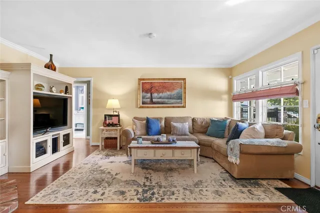 a living room with furniture a flat screen tv and a rug