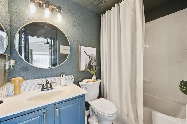 a bathroom with a toilet a sink and a mirror