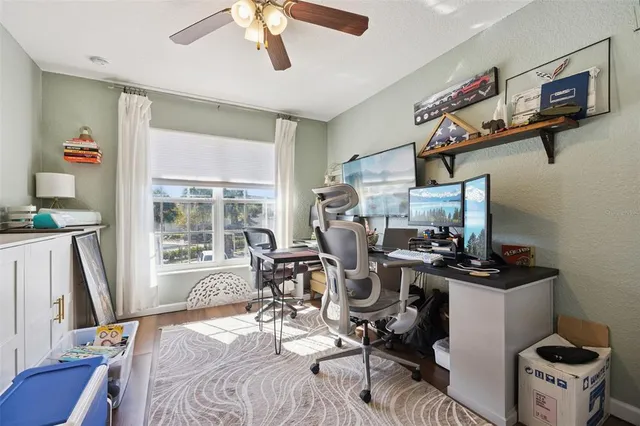 a view of a workspace with furniture and a window
