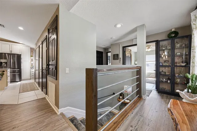 a view of kitchen with stainless steel appliances kitchen island hardwood floor and a window